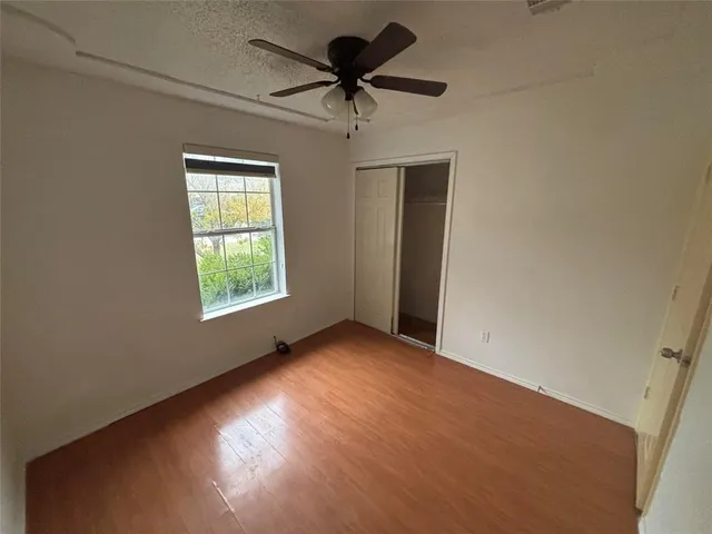 a view of room with window and a ceiling fan