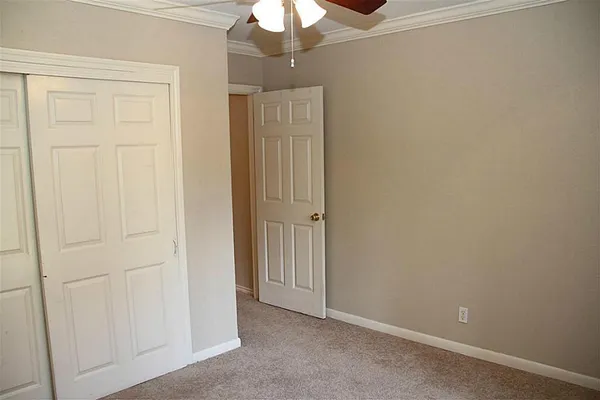 a view of a porch with wooden floor and a window