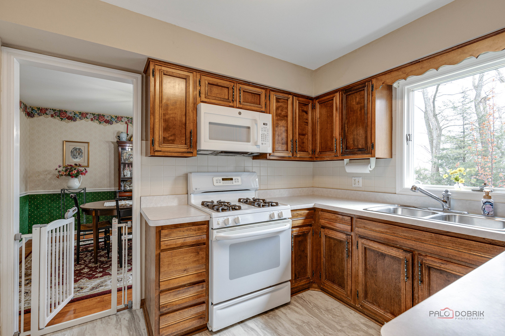 206 Pond Ridge Road Libertyville, IL 60048 - Photo 12 of 42 a kitchen with cabinets appliances a sink and a window