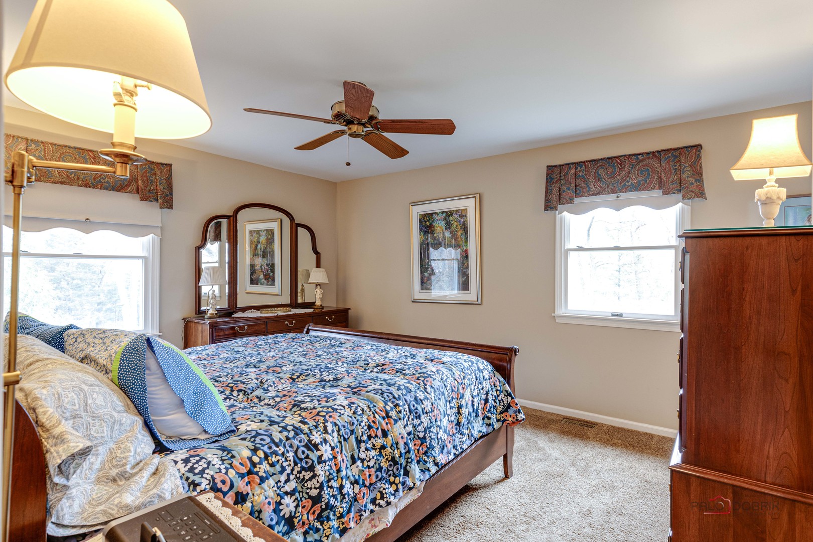 206 Pond Ridge Road Libertyville, IL 60048 - Photo 19 of 42 a bedroom with a large bed and wooden floor