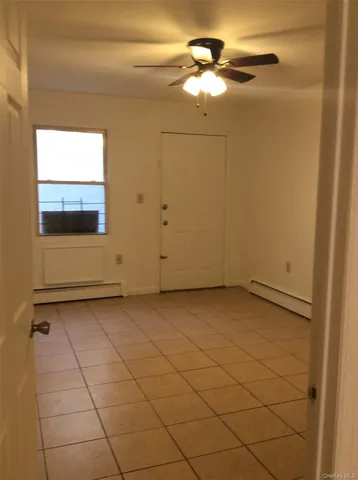 a view of a small space with wooden floor and a window