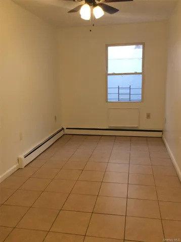 a view of a room with an empty space and a window