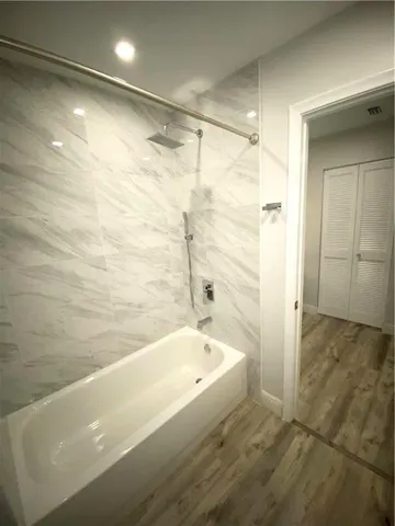 a bathroom with a bathtub and shower