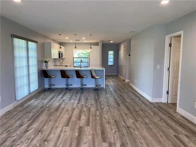 a living room with couch cabinet and a large window
