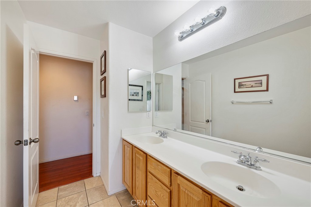 3819 St Austell Way Perris, CA 92571 - Photo 31 of 64 a bathroom with a double vanity sink mirror and shower