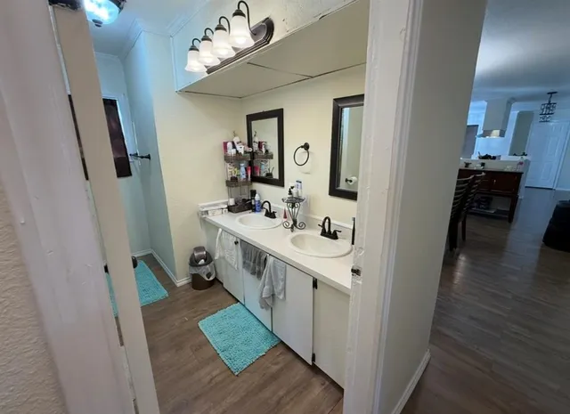a bathroom with a double vanity sink and a mirror