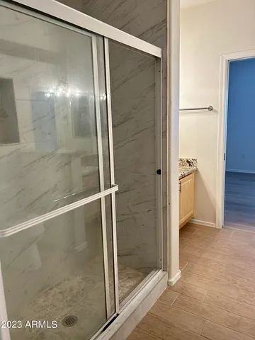 a bathroom with a glass shower door