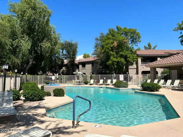 a view of a house with backyard sitting area and garden
