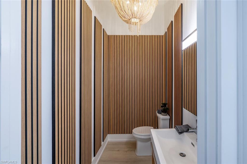 9240 The Lane Naples, FL 34109 - Photo 17 of 42 a bathroom with a toilet and a sink