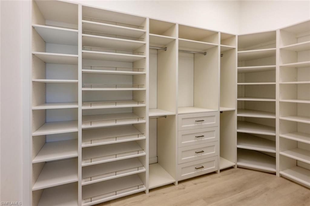 9240 The Lane Naples, FL 34109 - Photo 25 of 42 a view of walk in closet with empty racks