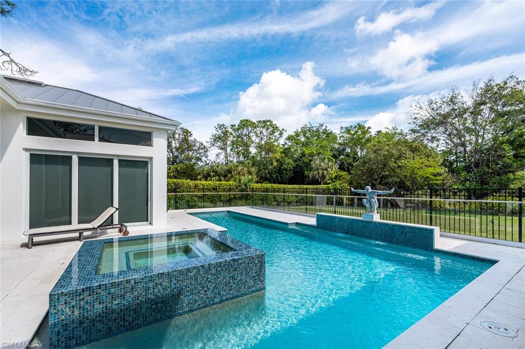 9240 The Lane Naples, FL 34109 - Photo 27 of 42 a view of a house with swimming pool and a yard