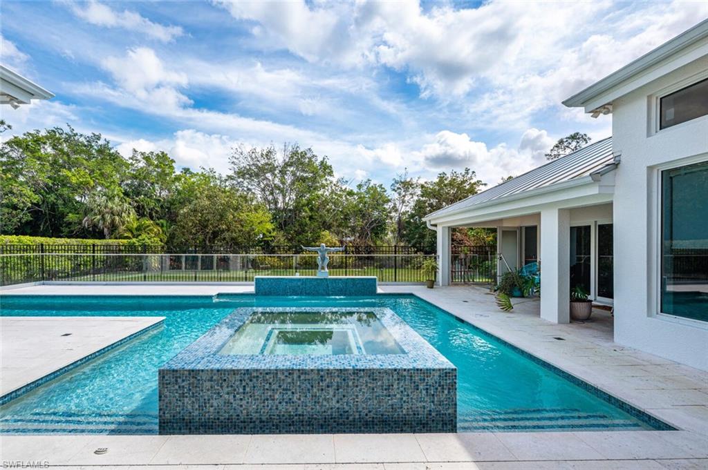 9240 The Lane Naples, FL 34109 - Photo 29 of 42 a view of backyard with swimming pool and seating