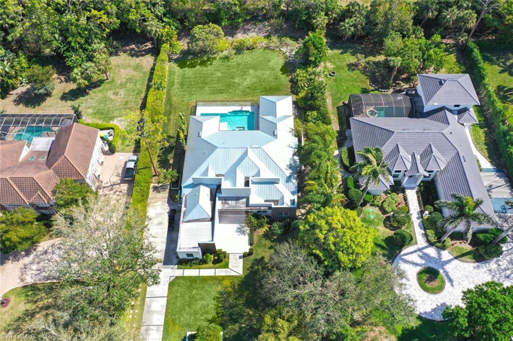 9240 The Lane Naples, FL 34109 - Photo 3 of 42 an aerial view of residential houses with outdoor space and street view