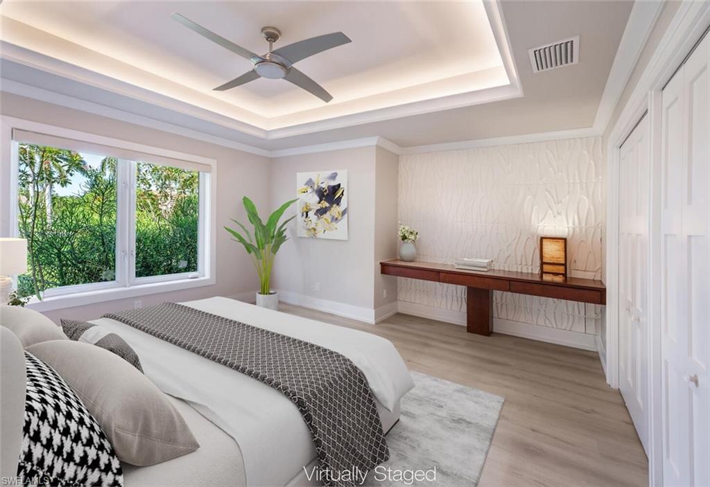 9240 The Lane Naples, FL 34109 - Photo 34 of 42 a bedroom with a bed and potted plant