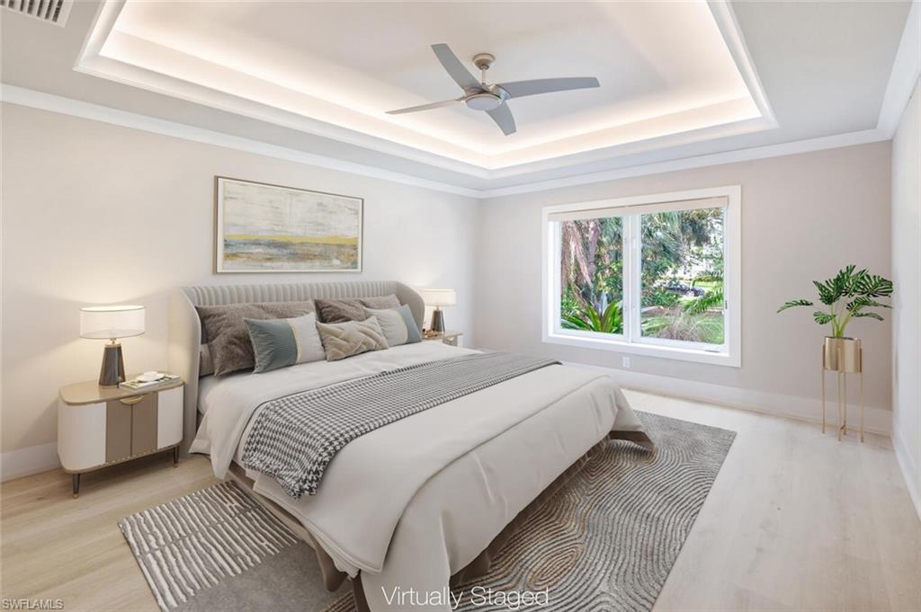 9240 The Lane Naples, FL 34109 - Photo 36 of 42 a bedroom with a large bed and a window
