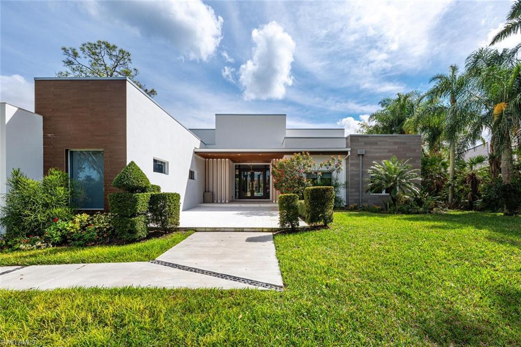 9240 The Lane Naples, FL 34109 - Photo 39 of 42 a front view of house with yard and green space