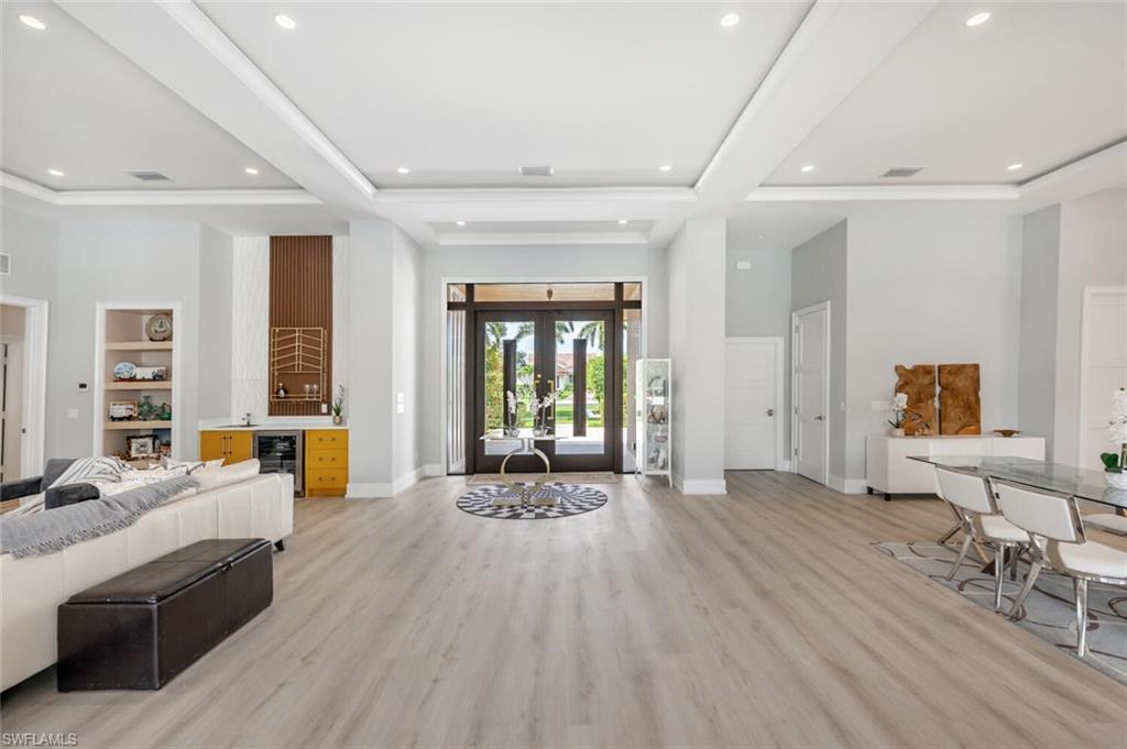 9240 The Lane Naples, FL 34109 - Photo 6 of 42 a large room with a large window and furniture