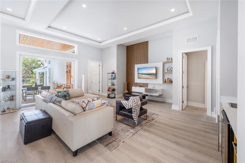 9240 The Lane Naples, FL 34109 - Photo 10 of 42 a living room with furniture and a wooden floor