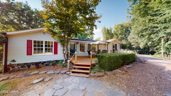 a view of a house with backyard and sitting area