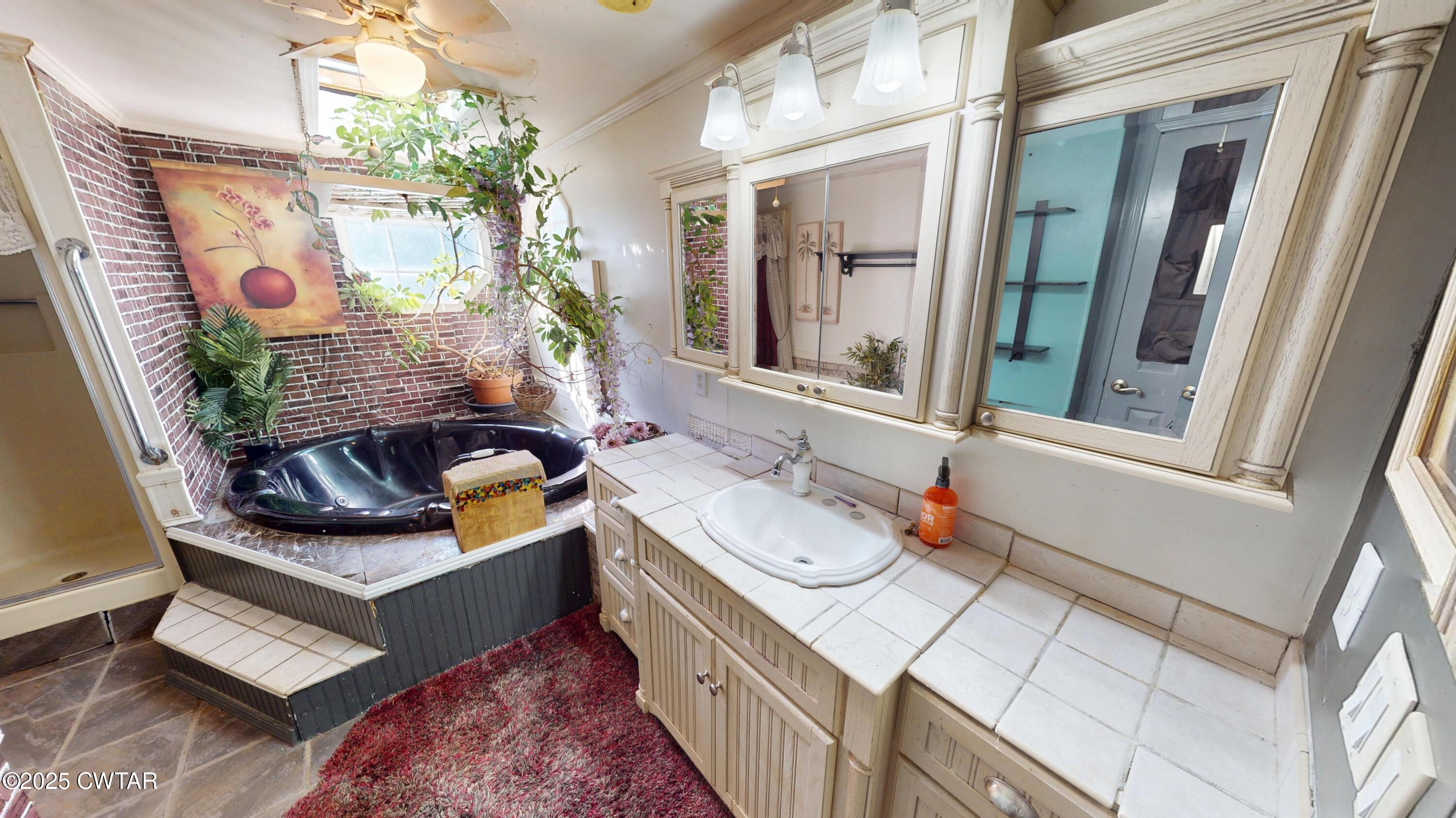 328 Cates Road Halls, TN 38040 - Photo 18 of 35 a bathroom with a granite countertop sink and a mirror