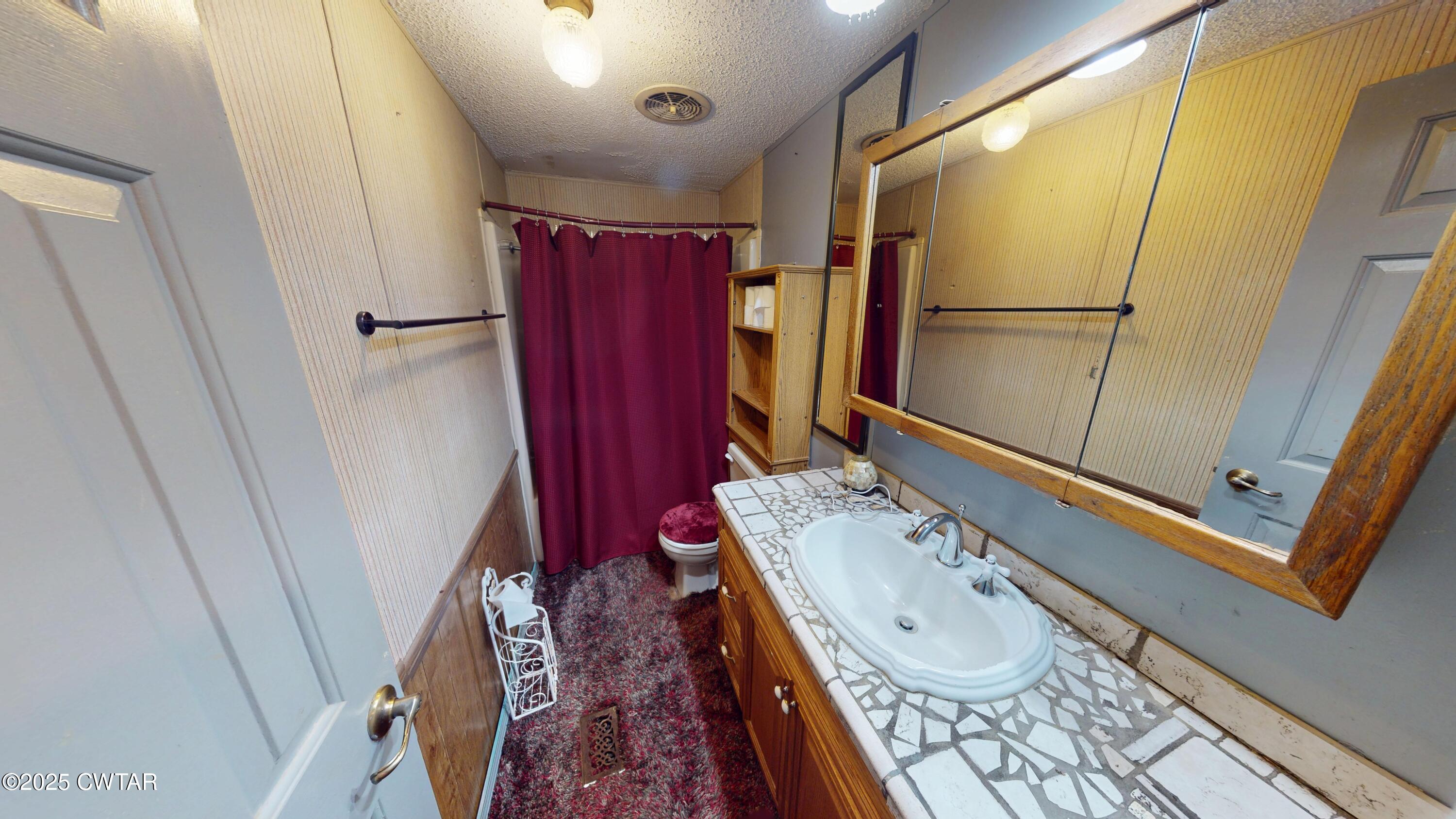 328 Cates Road Halls, TN 38040 - Photo 21 of 35 a bathroom with a sink a mirror and a shower