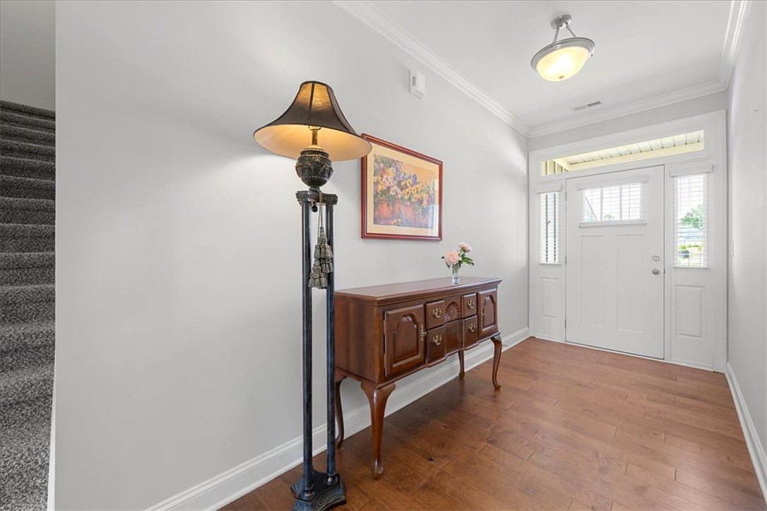 21 Barron Glenn Way Anderson, SC 29621 - Photo 7 of 48 The inviting entryway features gleaming hardwood flooring and a stylish front door with sidelight windows.