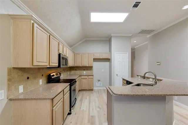 a kitchen with a sink stove and cabinets