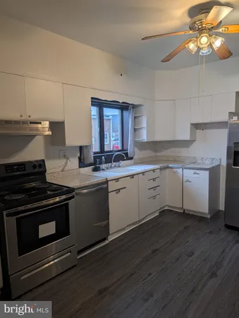 a kitchen with a stove a sink and a microwave