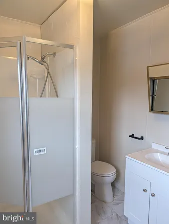 a bathroom with a toilet a sink and a mirror