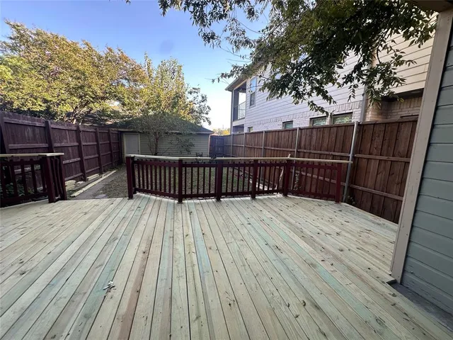 a view of backyard with wooden floor and trees
