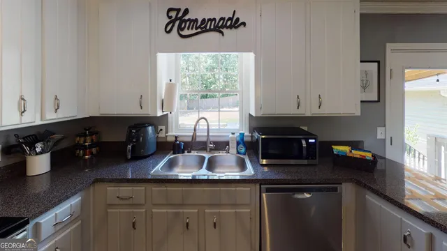 a kitchen with sink and cabinets