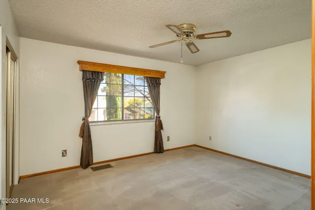 a view of a room with wooden floor and windows
