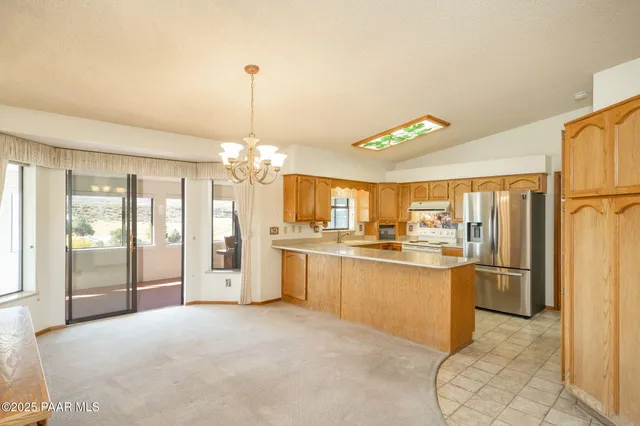 a spacious bathroom with a granite countertop sink a mirror and a shower