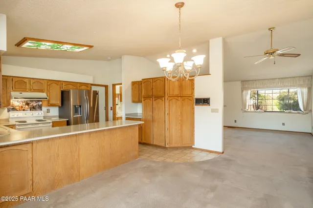 a view of an empty room with a fireplace and a window