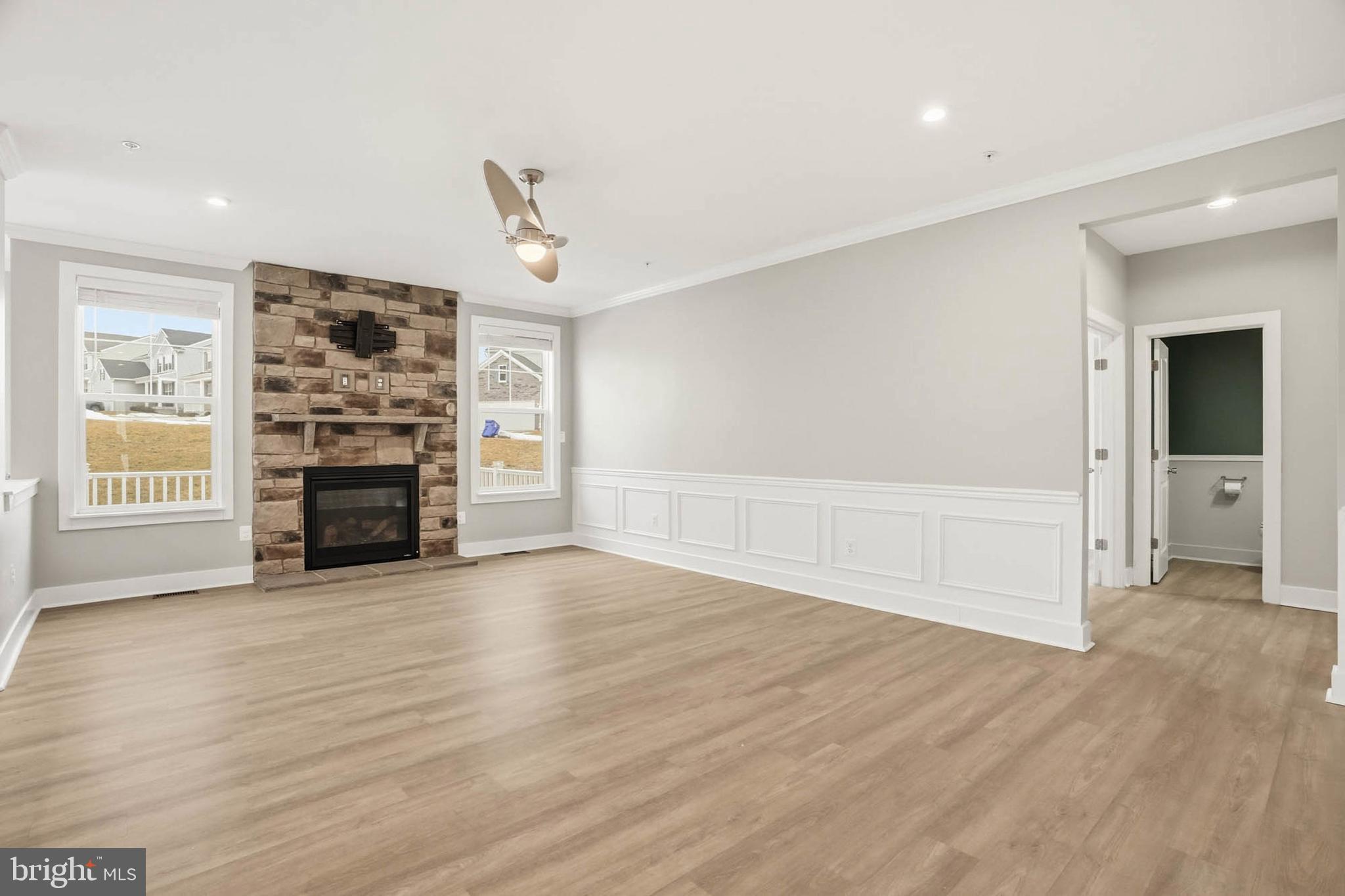 2305 Connor Circle Mount Airy, MD 21771 - Photo 13 of 44 an empty room with wooden floor fireplace and windows