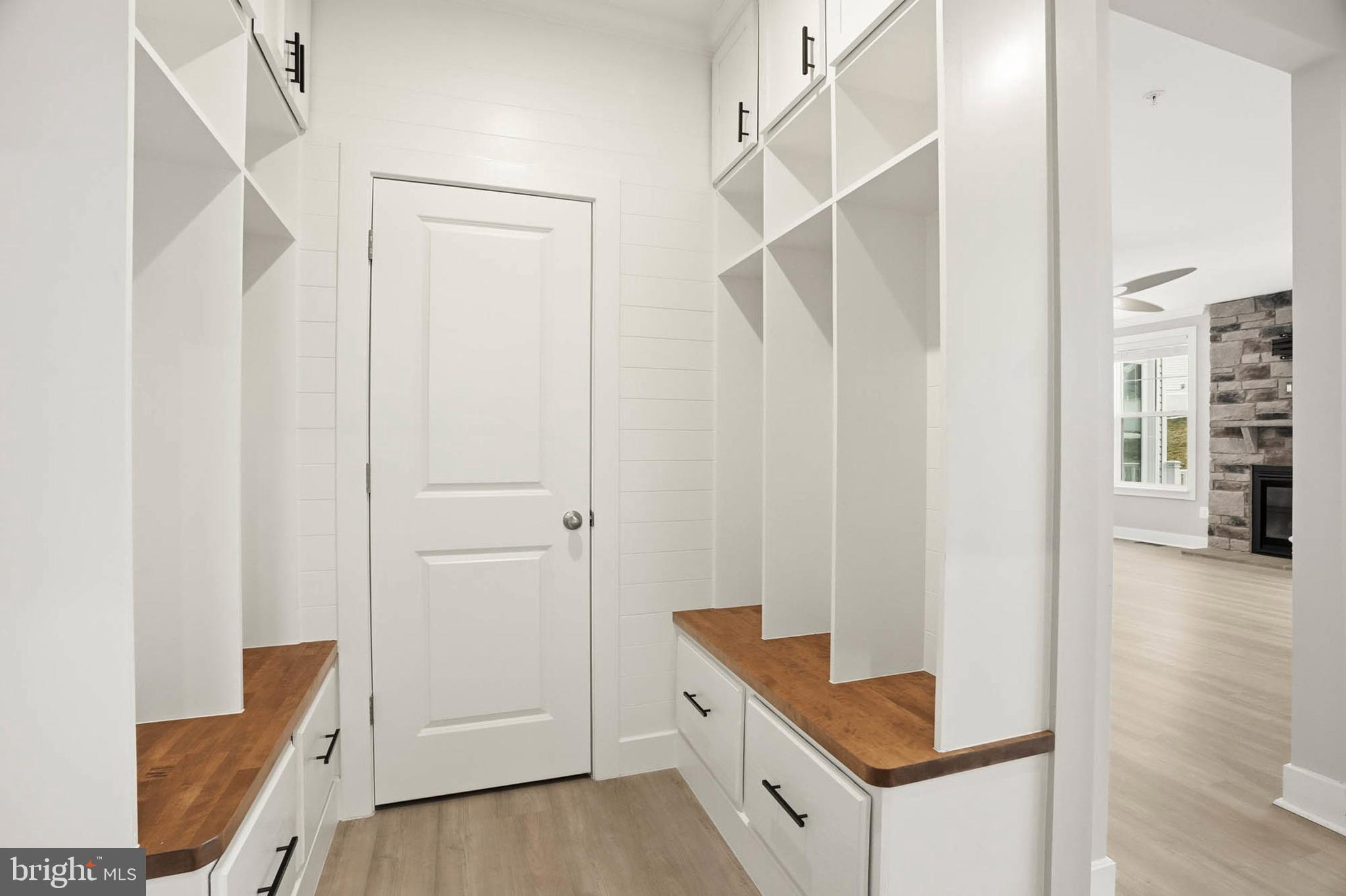 2305 Connor Circle Mount Airy, MD 21771 - Photo 18 of 44 a hallway with white cabinets and wooden floor