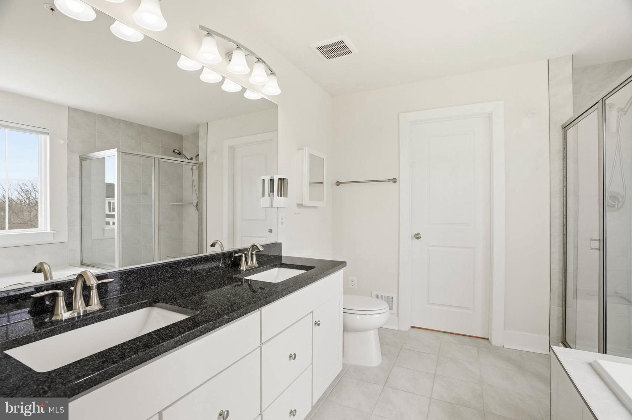2305 Connor Circle Mount Airy, MD 21771 - Photo 24 of 44 a bathroom with a granite countertop sink a toilet a mirror and shower