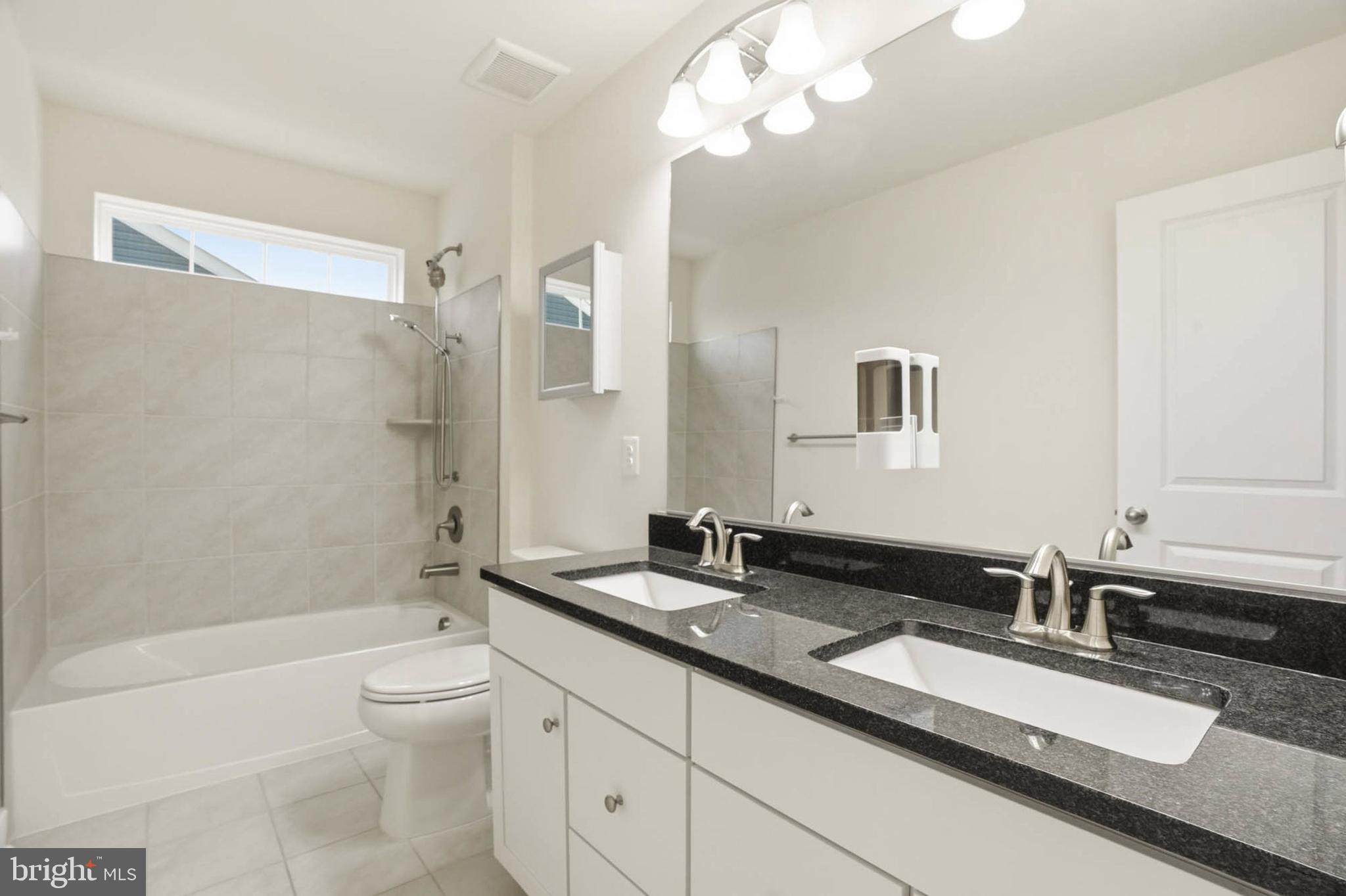 2305 Connor Circle Mount Airy, MD 21771 - Photo 32 of 44 a bathroom with a granite countertop sink a toilet a mirror and shower