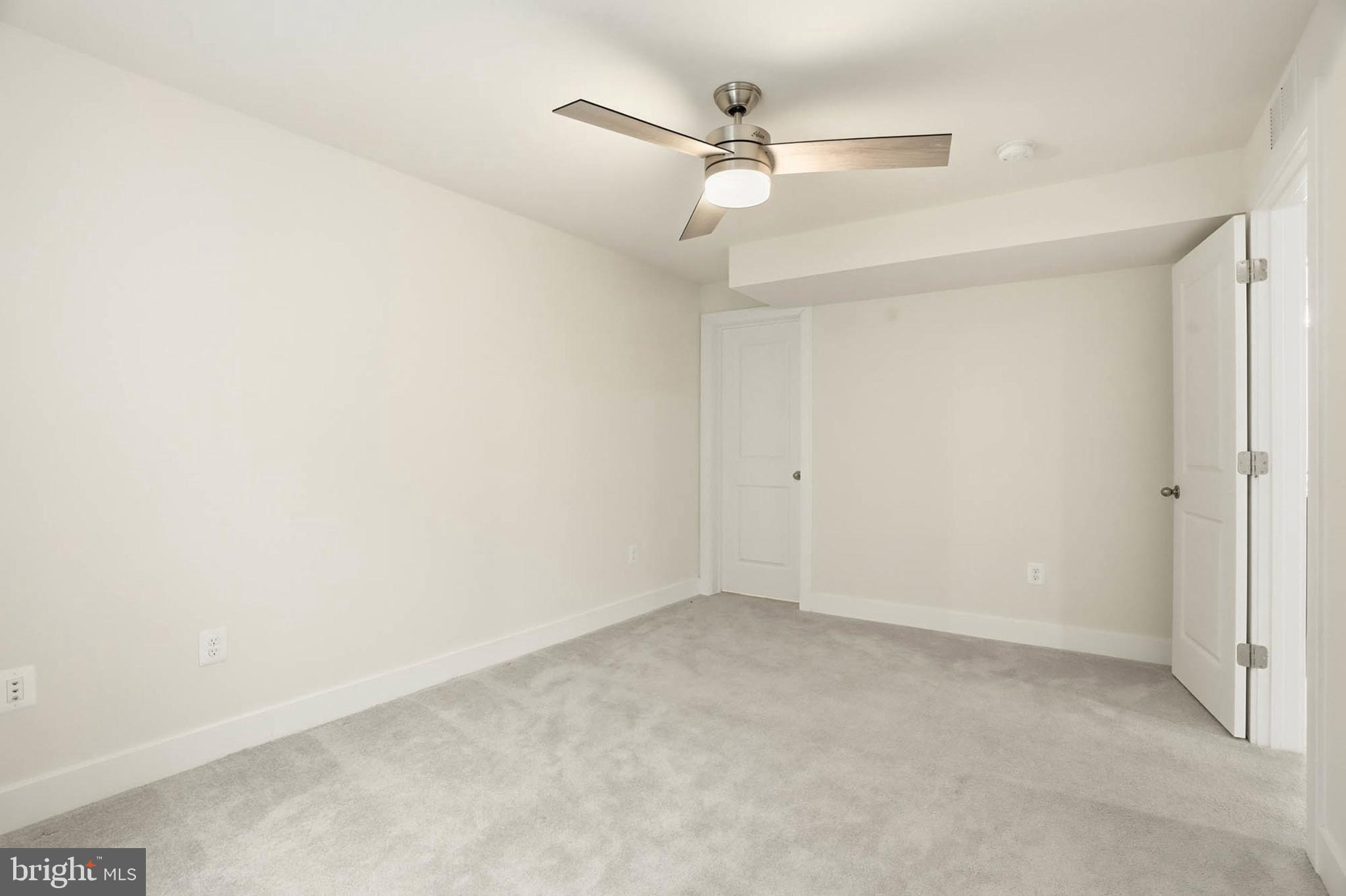 2305 Connor Circle Mount Airy, MD 21771 - Photo 36 of 44 an empty room with a ceiling fan and a window