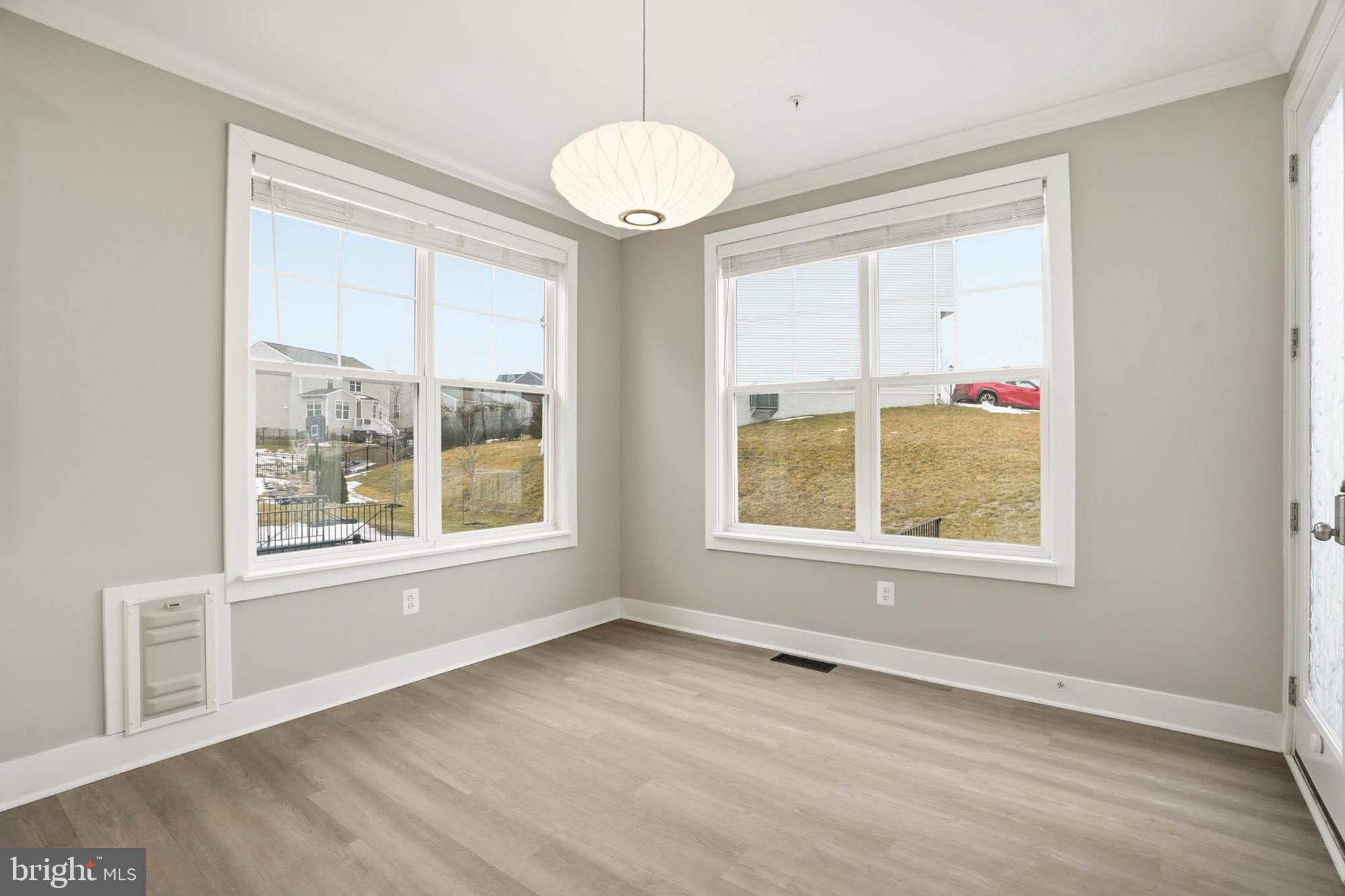 2305 Connor Circle Mount Airy, MD 21771 - Photo 9 of 44 a view of an empty room with a window and wooden floor