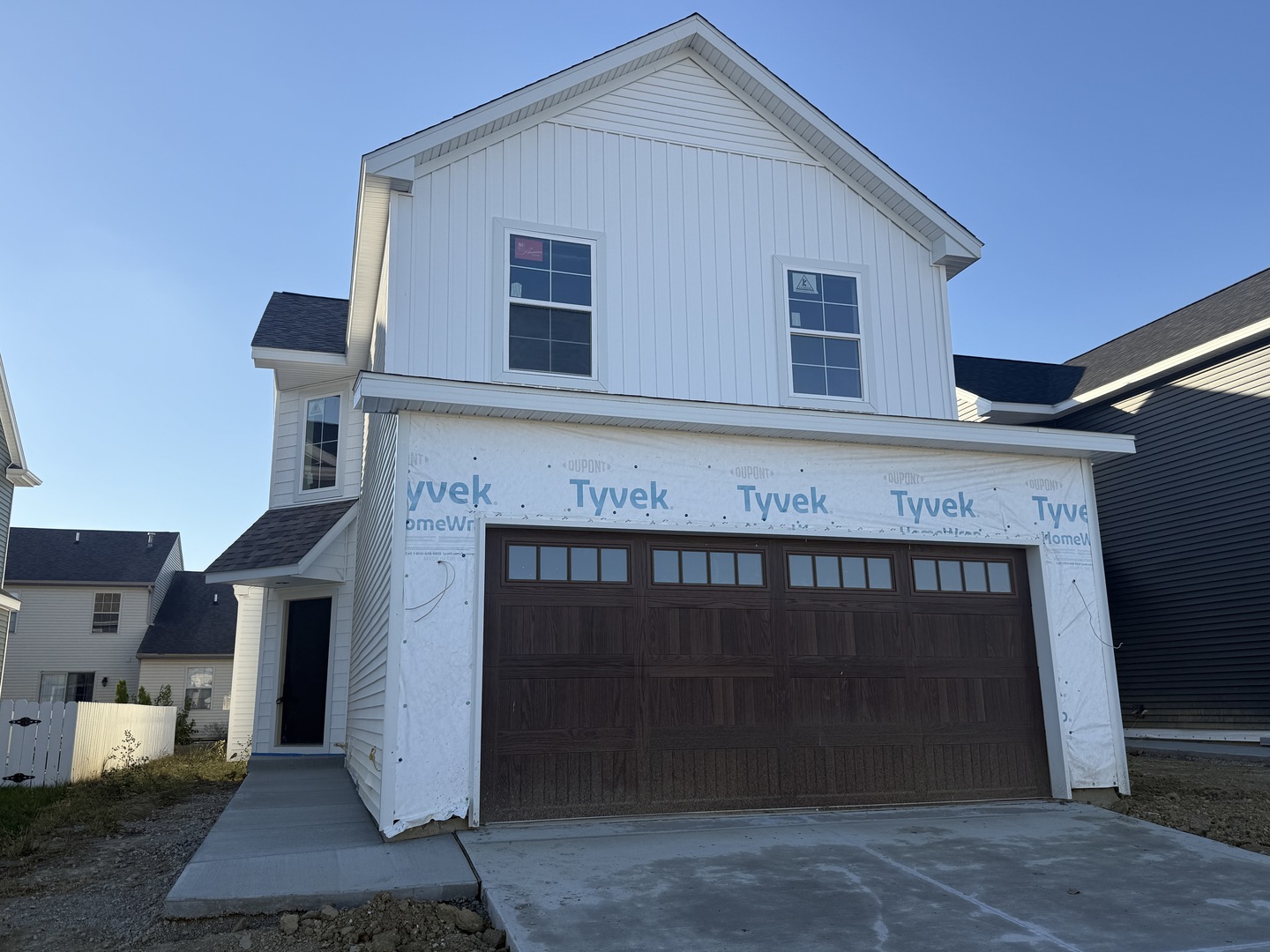a front view of a house with yard and garage