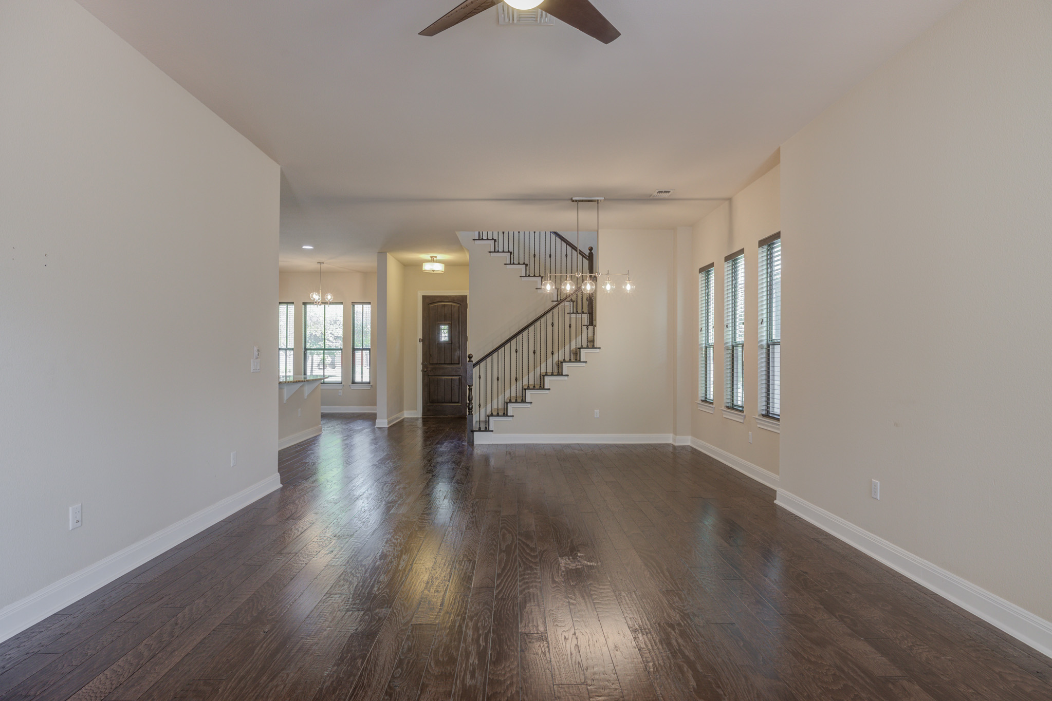4524 Berkman Drive Austin, TX 78723 - Photo 18 of 38 Spacious interior featuring dark wood-finish flooring, light neutral wall tones, and white baseboards