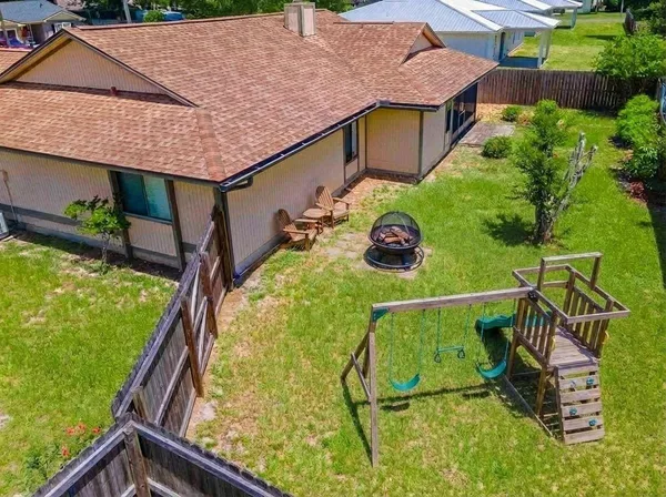 an aerial view of a house with swimming pool garden and patio
