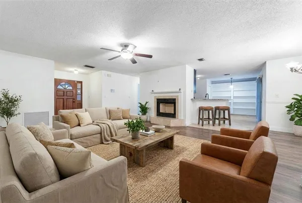 a living room with furniture dining table and a fireplace