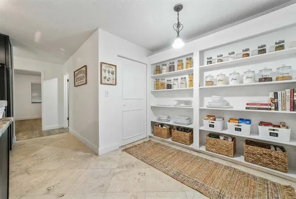 a view of kitchen with cabinets and refrigerator