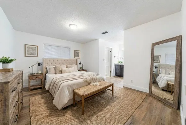 a spacious bedroom with a bed and a walk in closet