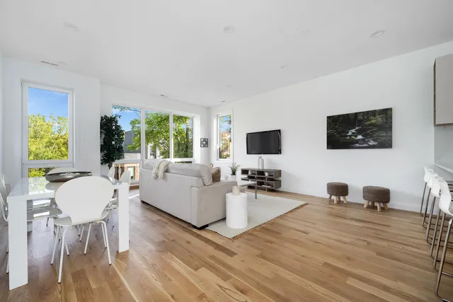 a living room with furniture flat screen tv and a couch