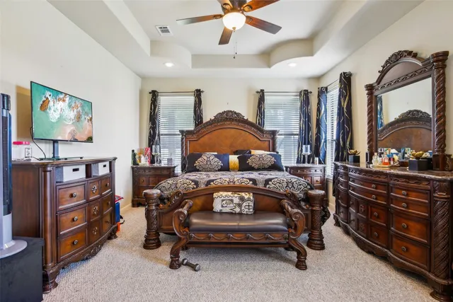 a bedroom with a bed and a dresser in it
