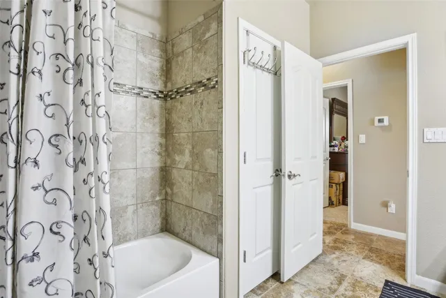 a bathroom with a bathtub and a shower