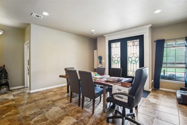a dining room with furniture and window